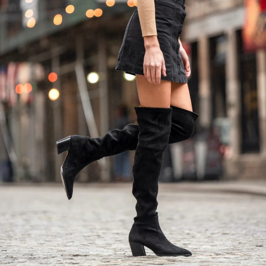 Wear a pinafore dress with high boots